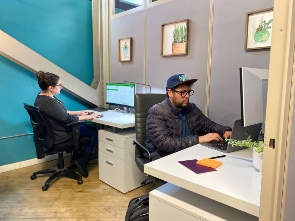 Two members meeting at a collaboration table discussing business