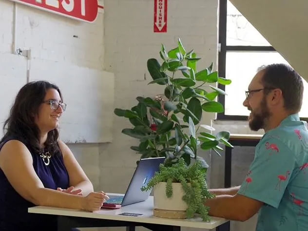 Two members meeting at a collaboration table discussing business