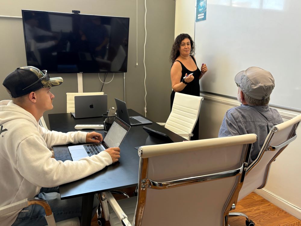 Woman using computer desk at Cowork and Connect as part of their amenities