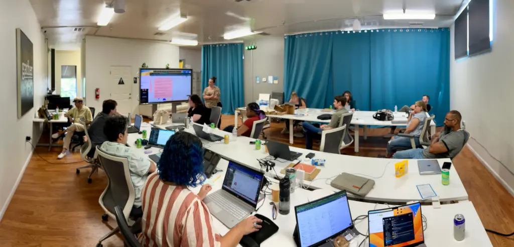 A group watching a presentation in Cowork + Connect